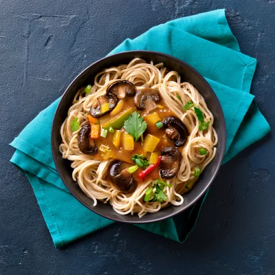 Bowl Of Stir Fried Noodles With Mushrooms And Vegetables