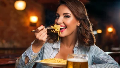Woman Eating Spaghetti and Drinking Beer in Restaurant
