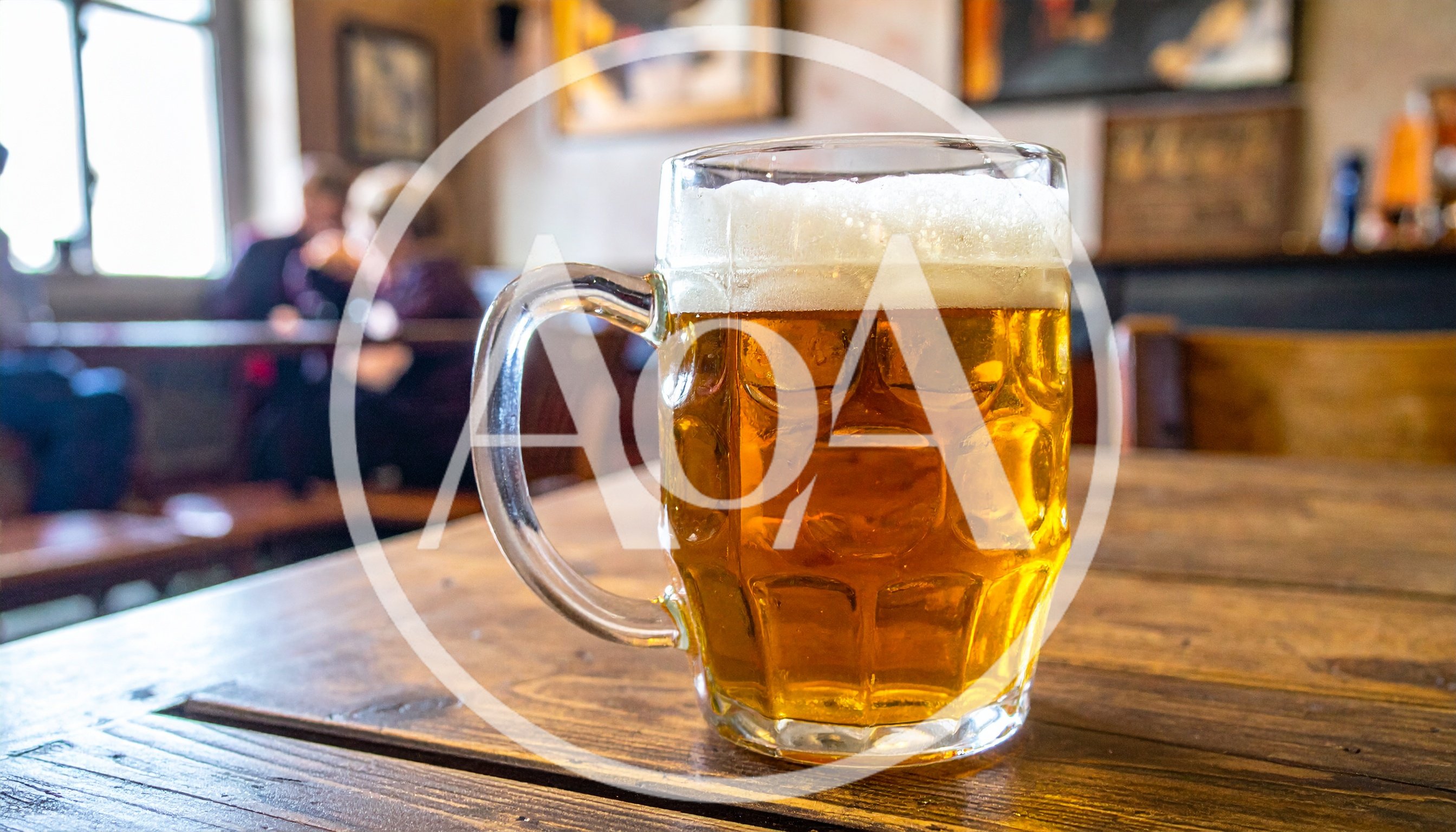 Full Glass Beer Mug On A Wooden Pub Table