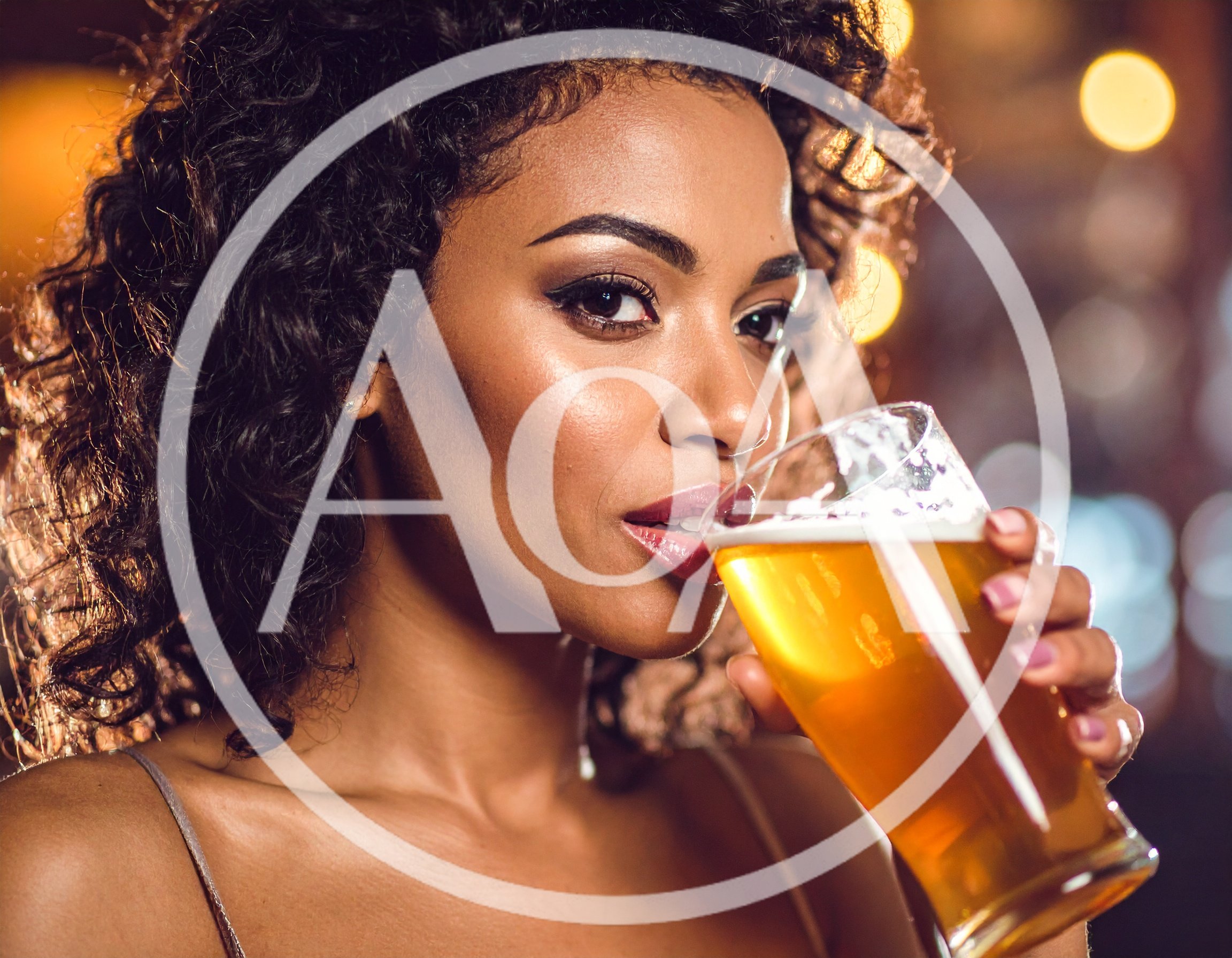 Beautiful Woman Drinking Beer at a Nightclub