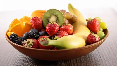 Fresh Assorted Fruits In A Rustic Ceramic Bowl