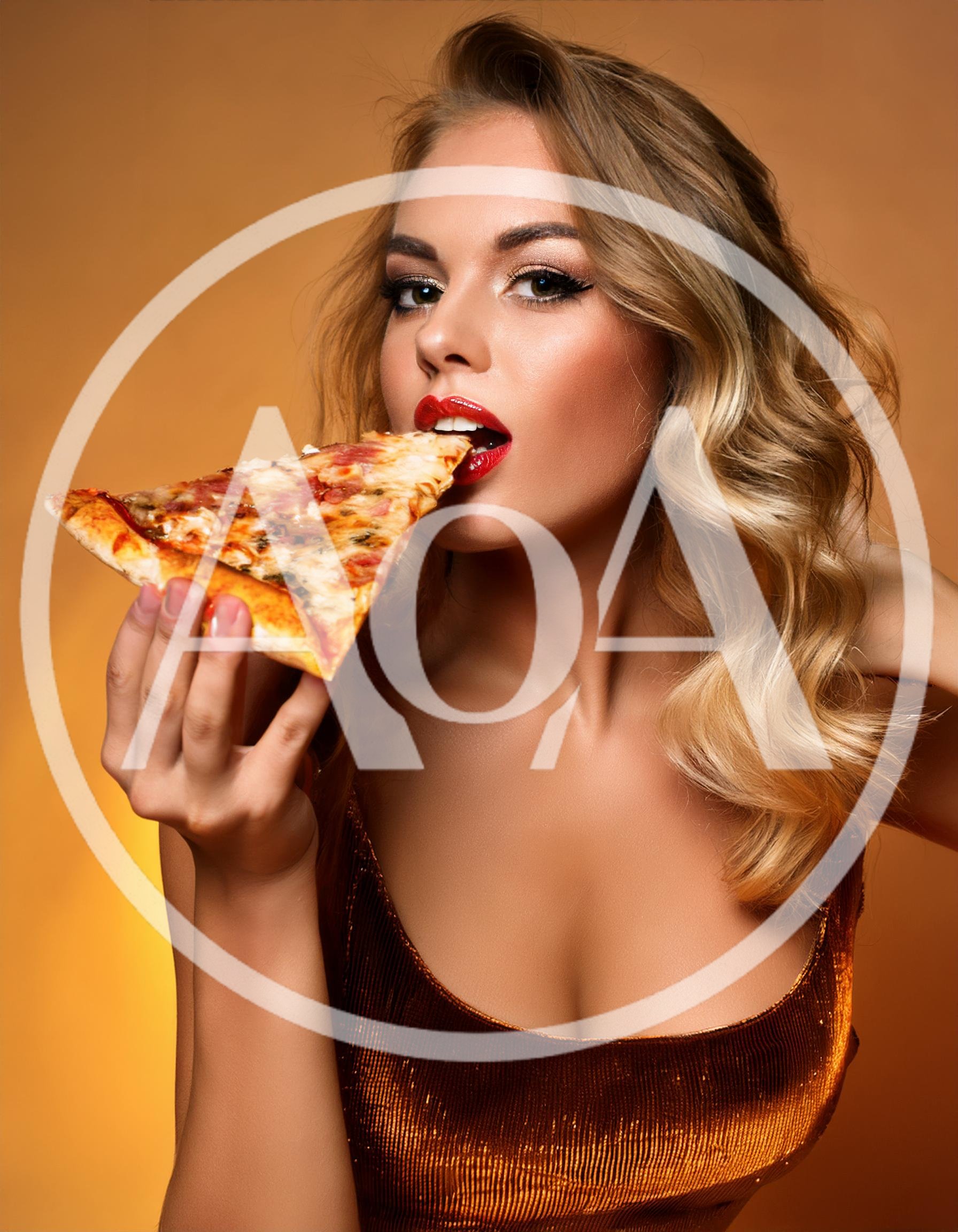Beautiful Blonde Woman Eating A Slice Of Pizza
