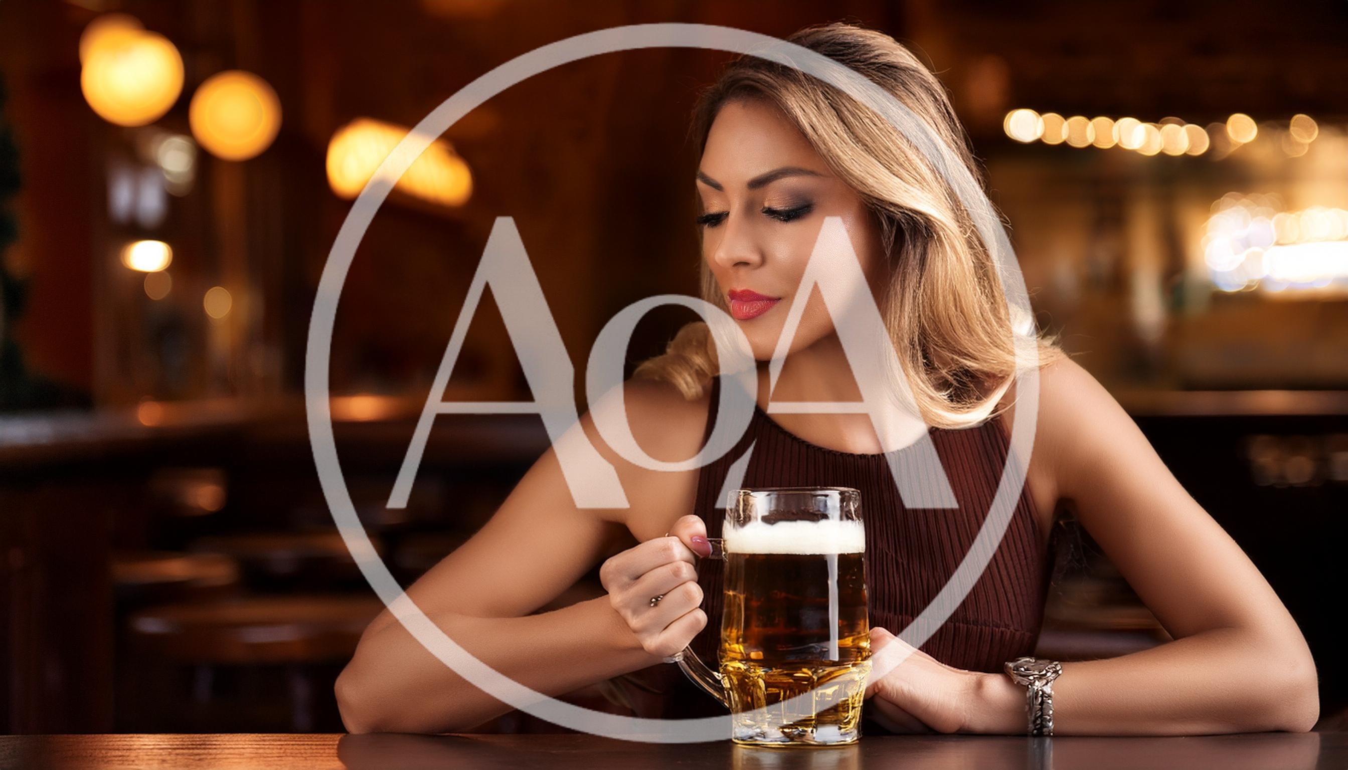 Young Woman Holding A Beer Mug In A Bar