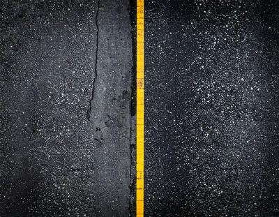 Top Down View Of Wet Asphalt Road With Yellow Line