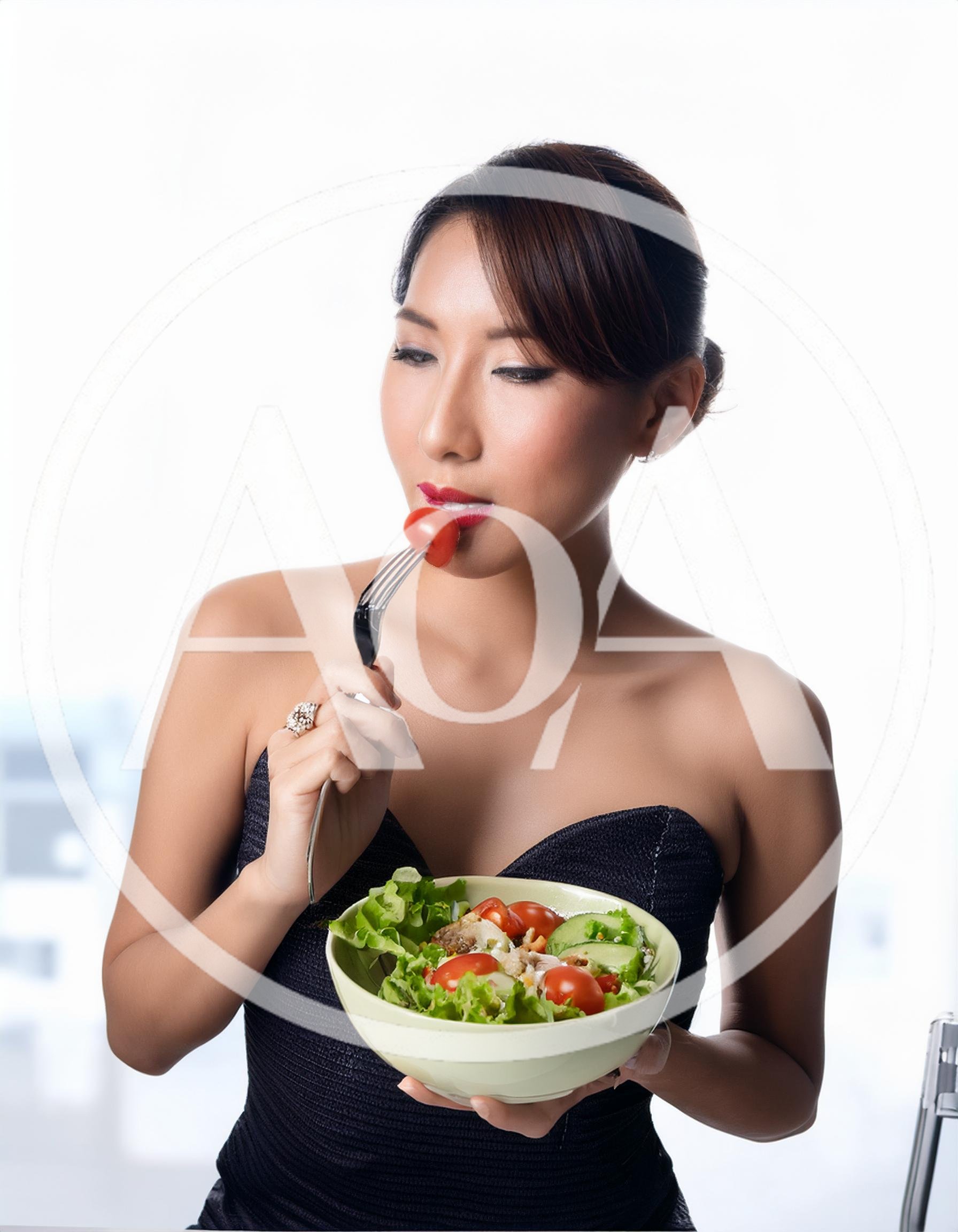 Elegant Woman Eating Fresh Salad With A Fork