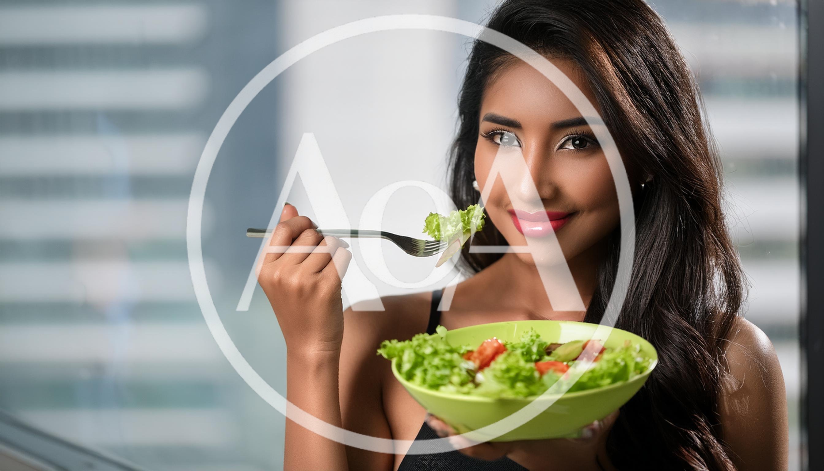 Young Woman Eating Fresh Salad In Modern Office