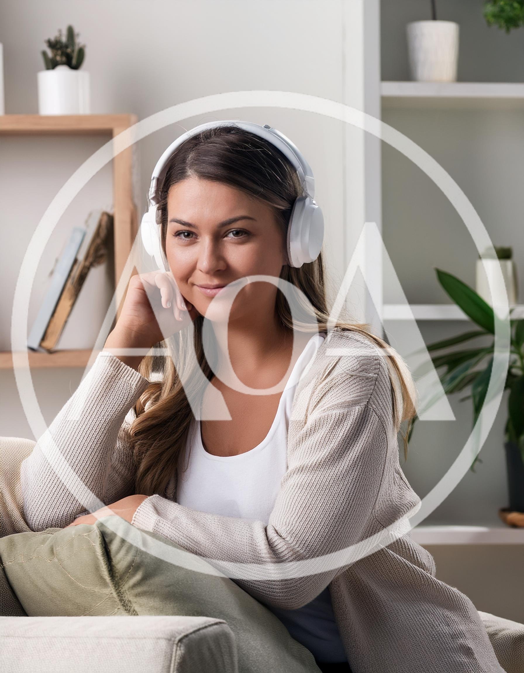 Young Woman Wearing Headphones Relaxing On A Sofa