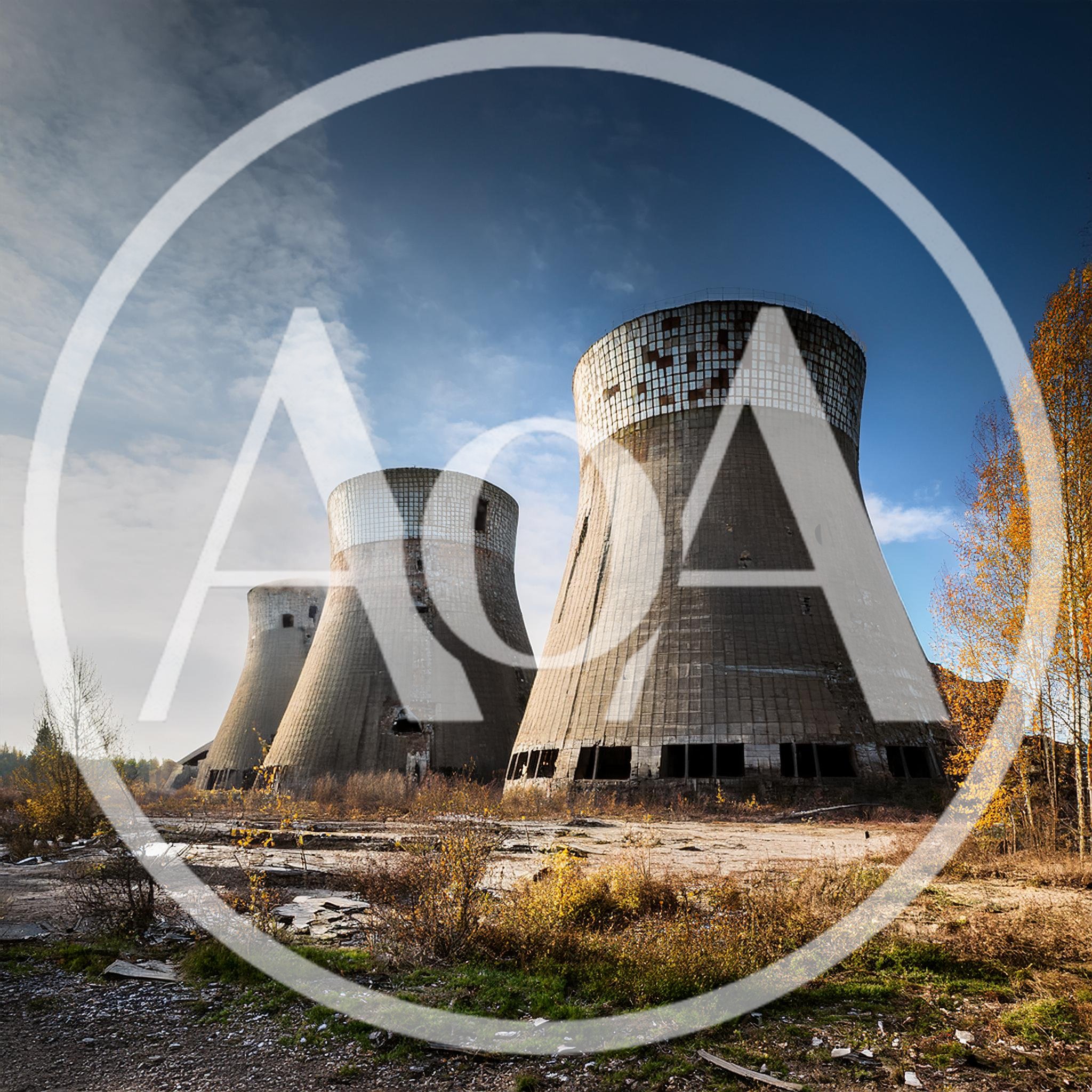 Abandoned Industrial Cooling Towers In A Desolate Landscape