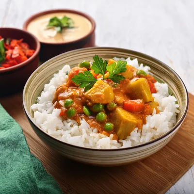 Bowl Of Vegetable Curry With Steamed White Rice