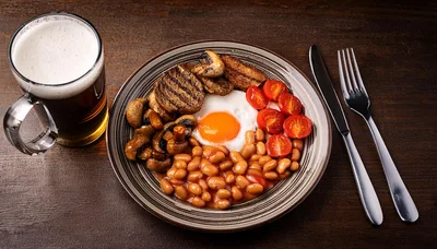 Full English Breakfast With Beer On Wooden Table