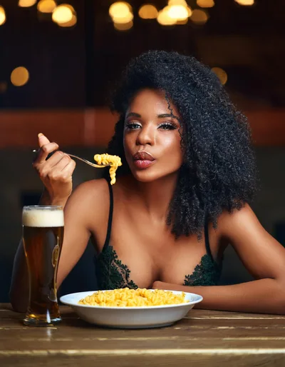 Beautiful Woman Eating Pasta With Beer In A Restaurant