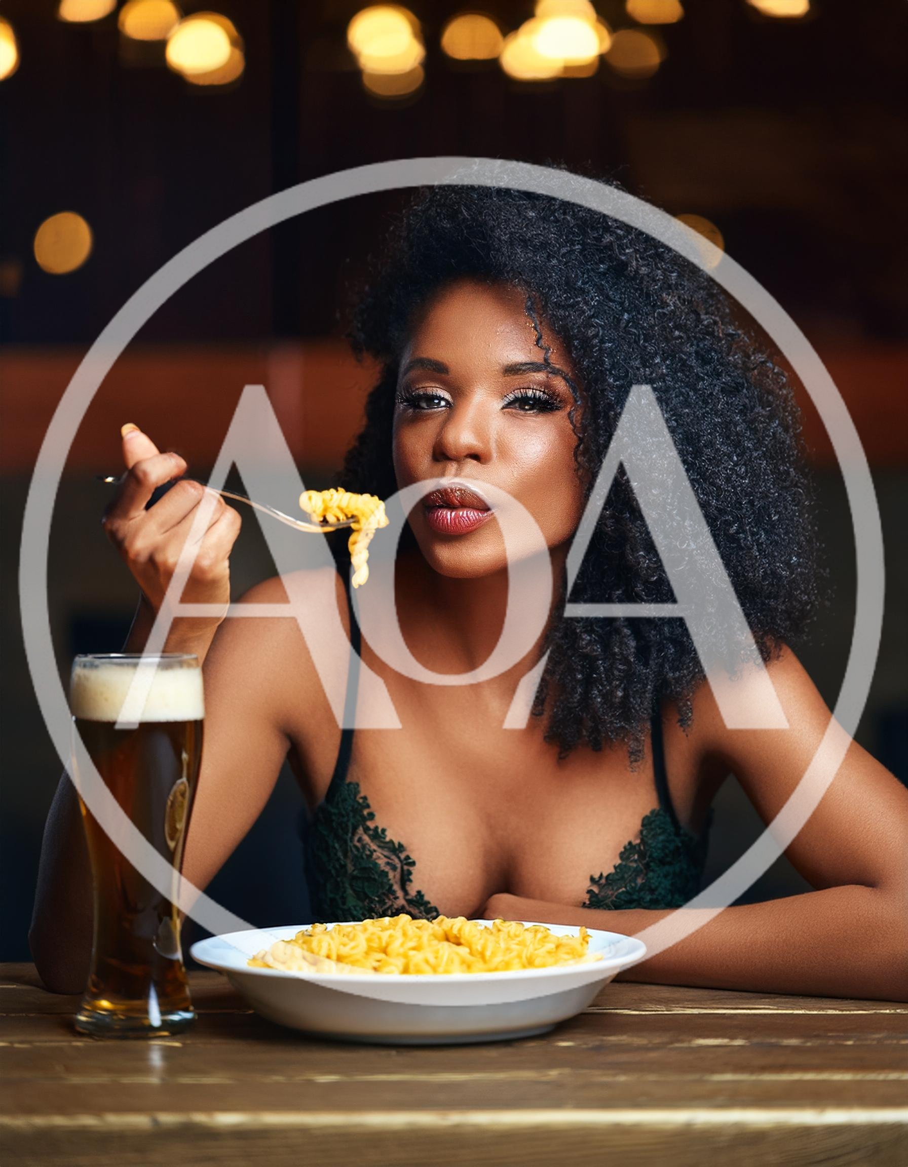 Beautiful Woman Eating Pasta With Beer In A Restaurant