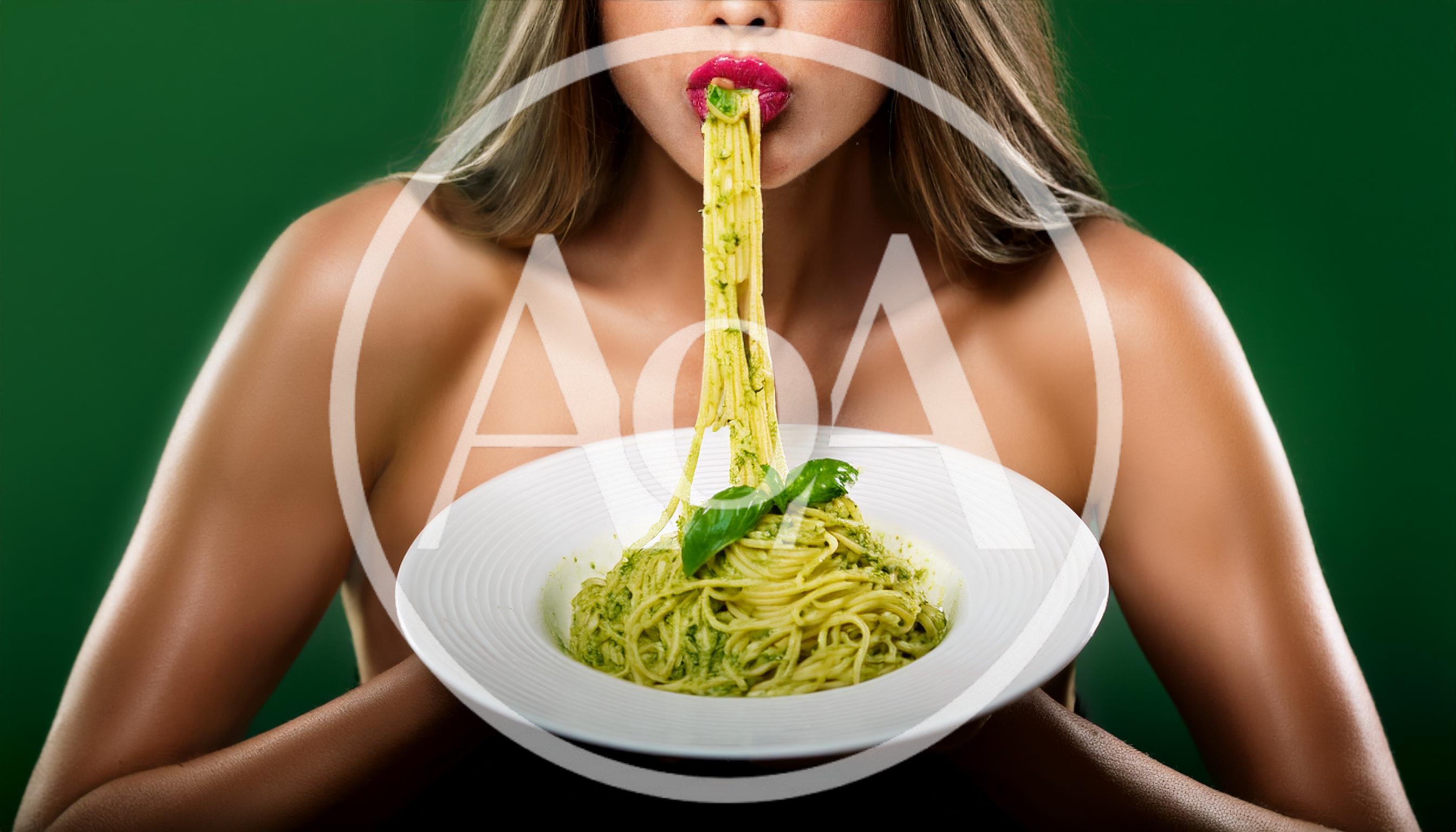 Woman Eating Pesto Pasta From A White Plate