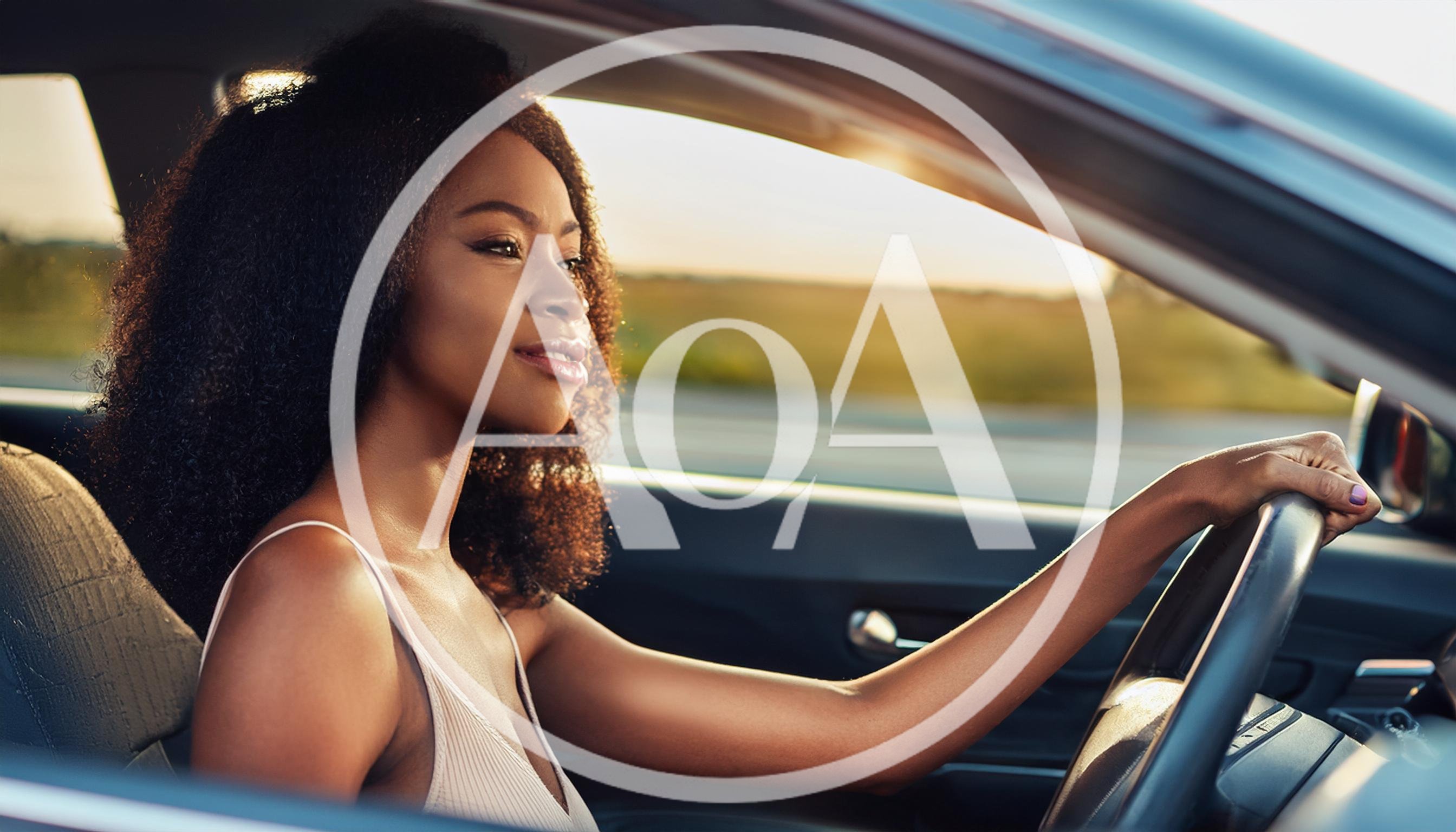 Young Black Woman Driving A Car At Sunset