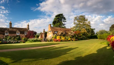 Picturesque English Cottage Garden With Lush Green Lawn