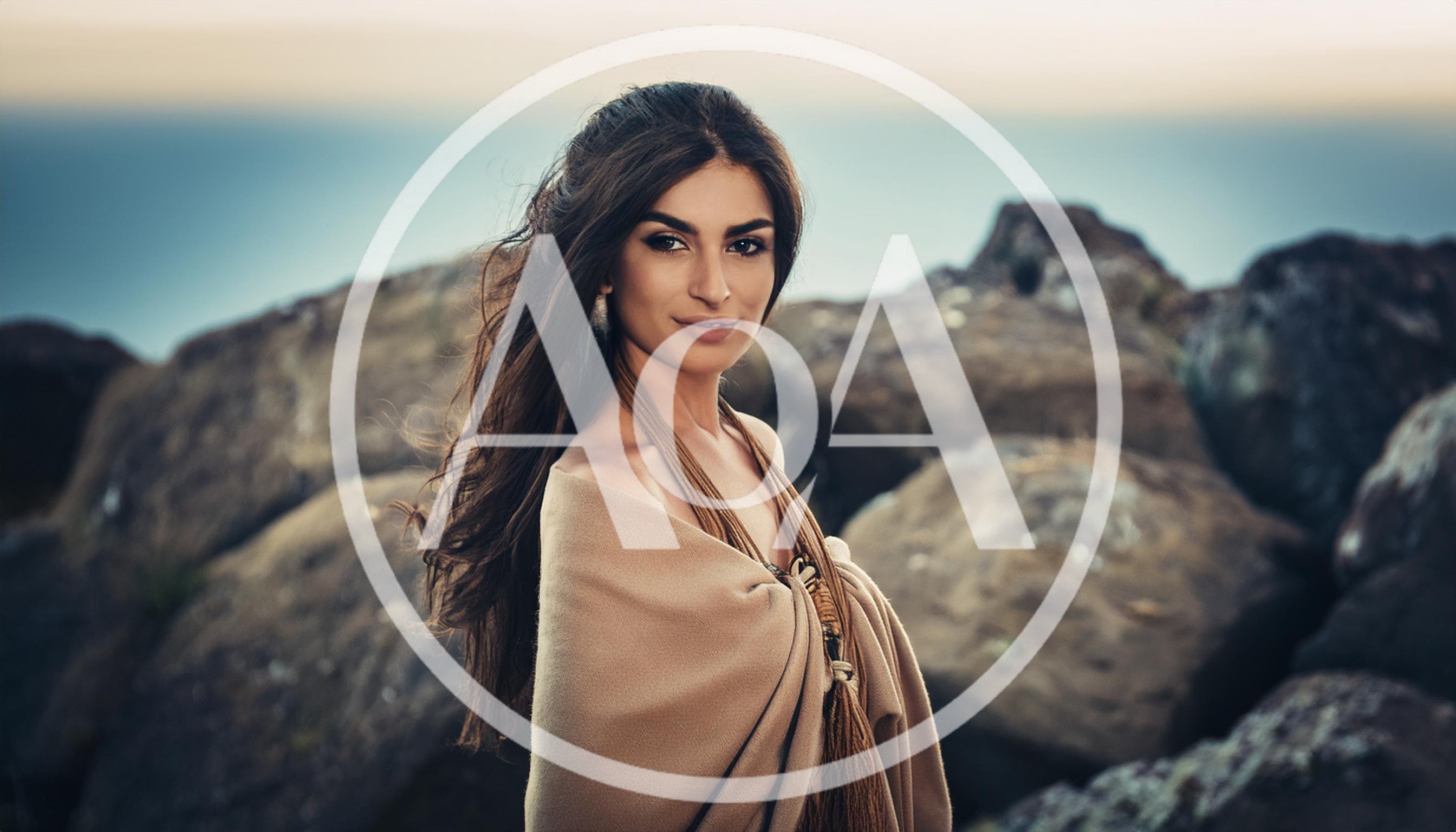 Portrait Of A Beautiful Woman Standing On Rocky Coast
