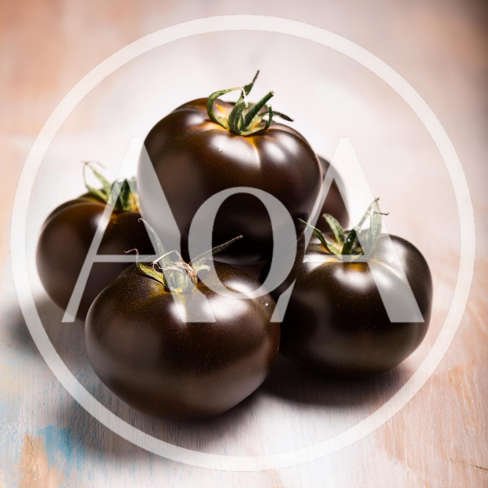 Fresh Kumato Tomatoes On A Rustic Wooden Surface