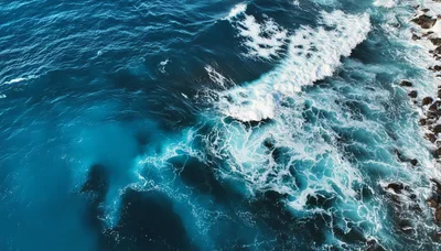 Aerial View Of Ocean Waves Crashing Against Rocky Shoreline