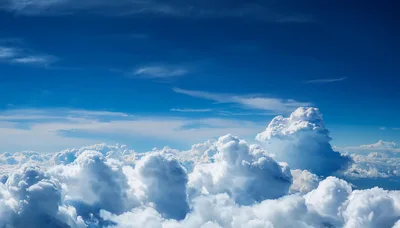 Aerial View Of Fluffy White Clouds In Blue Sky