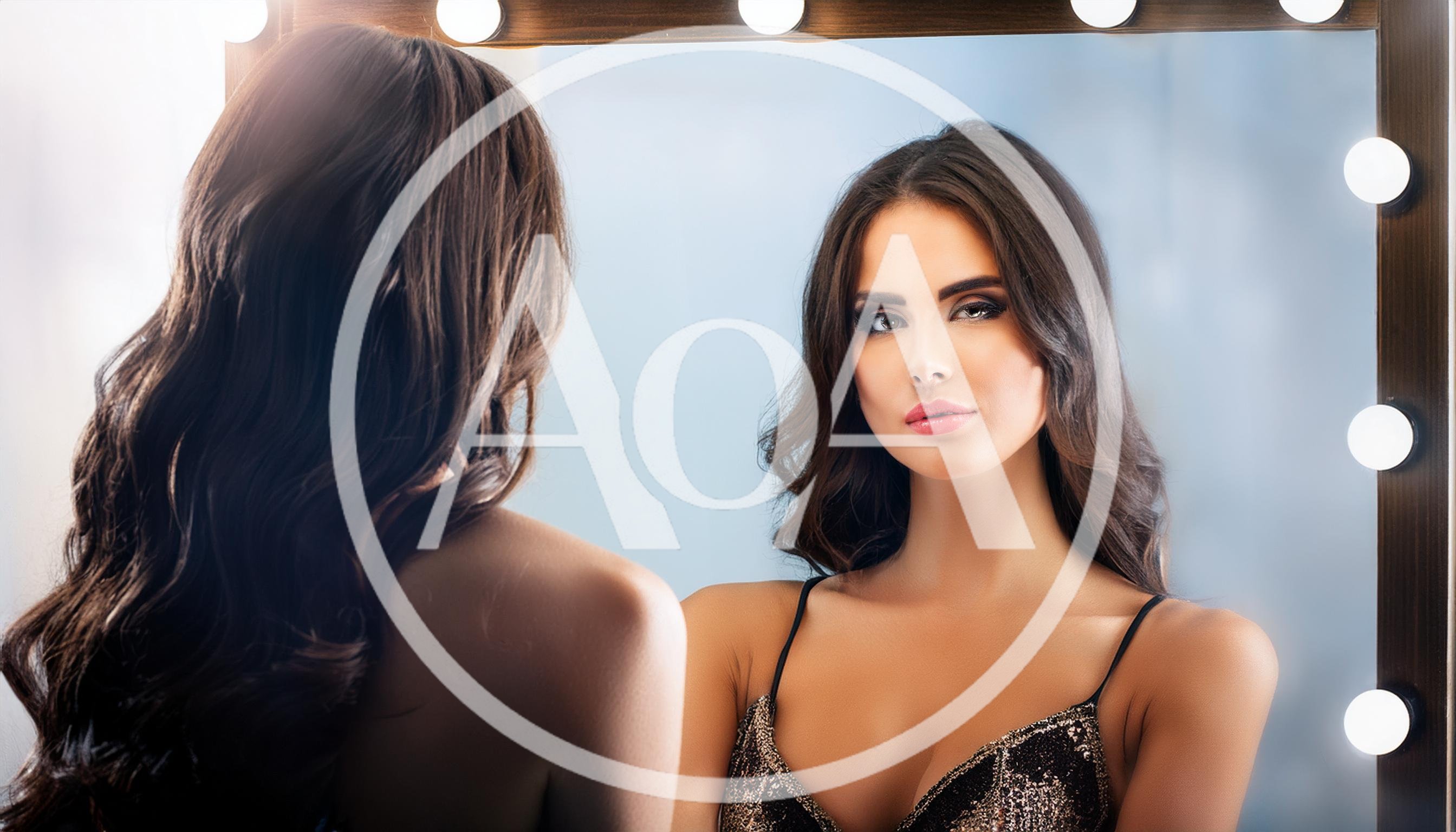Beautiful Woman Looking At Her Reflection In Vanity Mirror
