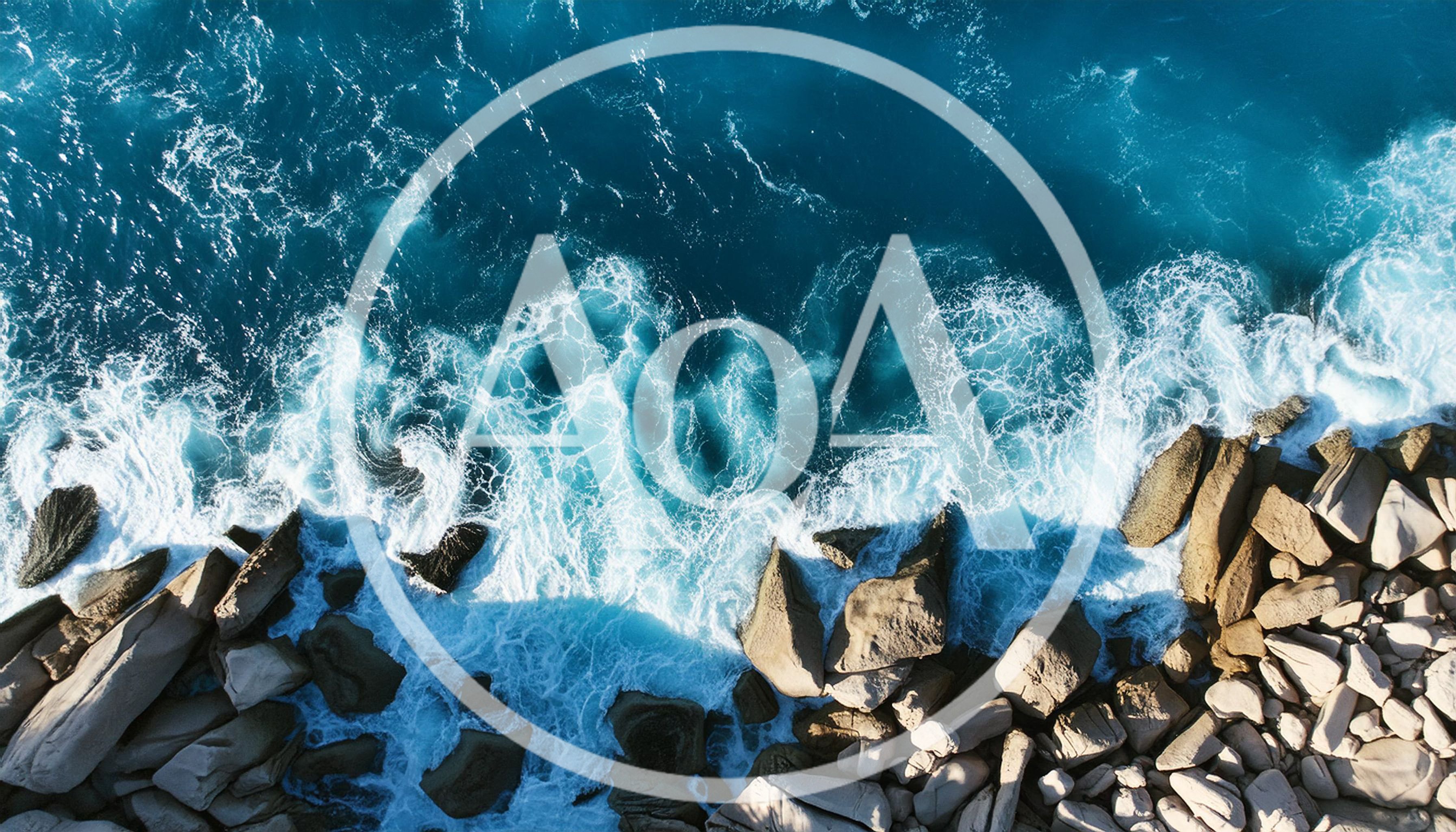 Aerial View Of Ocean Waves Crashing Against Rocky Shore