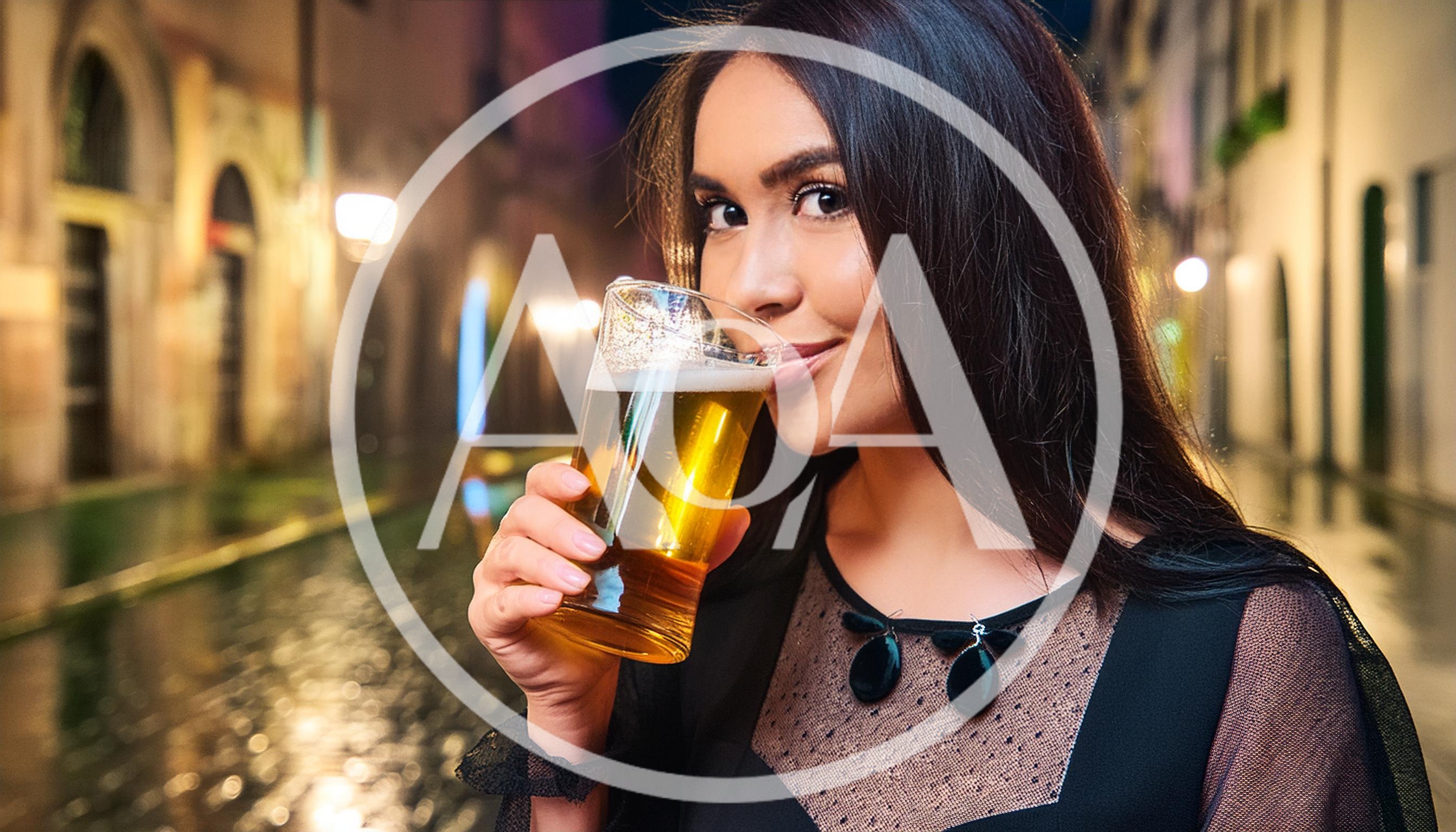 Young Woman Drinking Beer In A European City Street