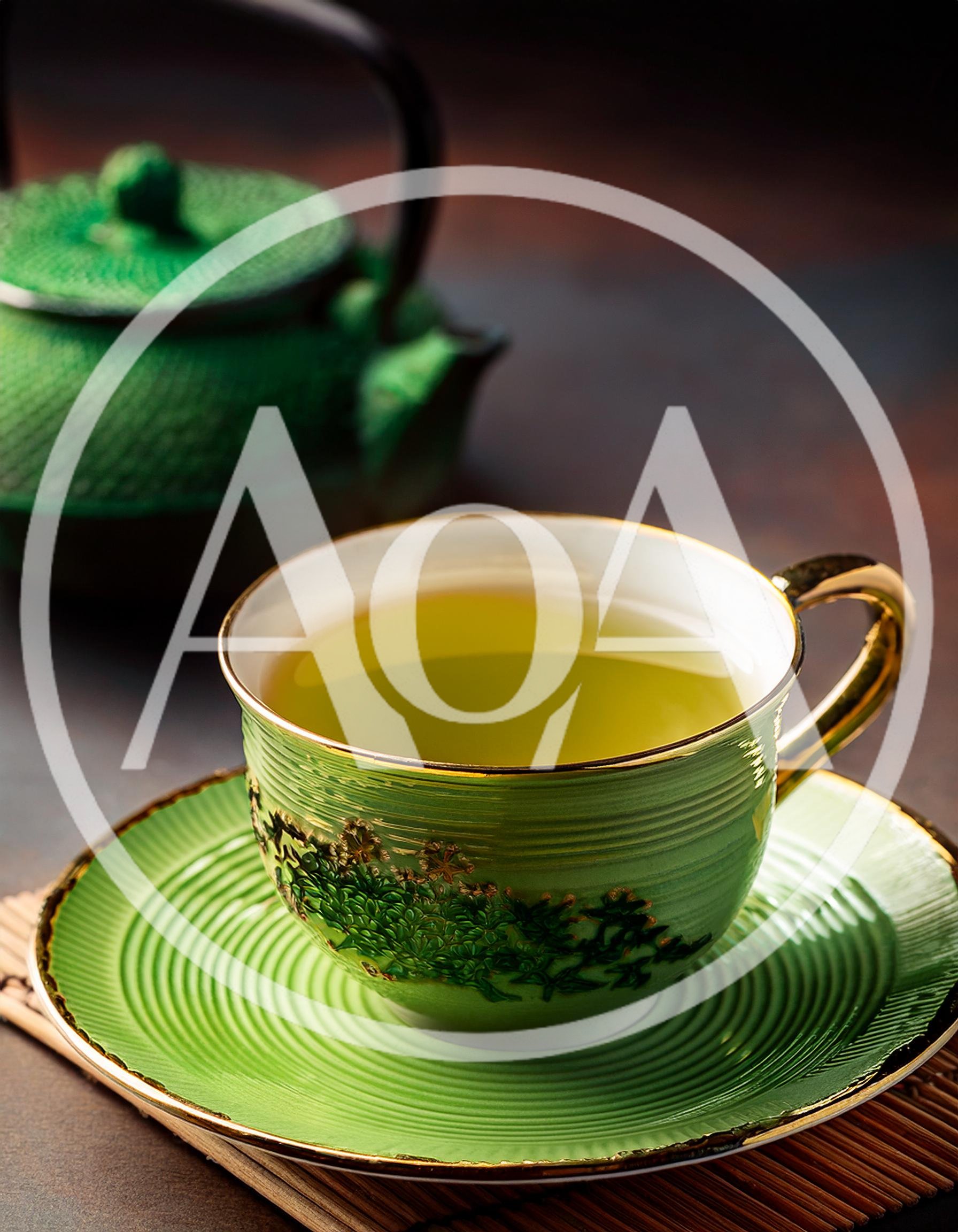 Green Tea Cup And Teapot On A Bamboo Mat