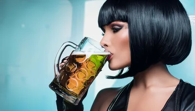 Woman With Bob Haircut Drinking Beer From Glass Mug