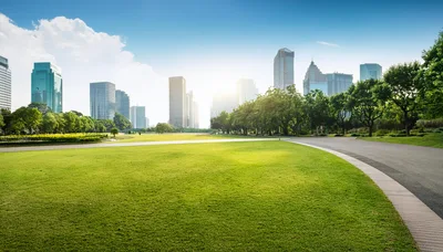 Modern City Park With Lush Green Lawn And Skyscrapers