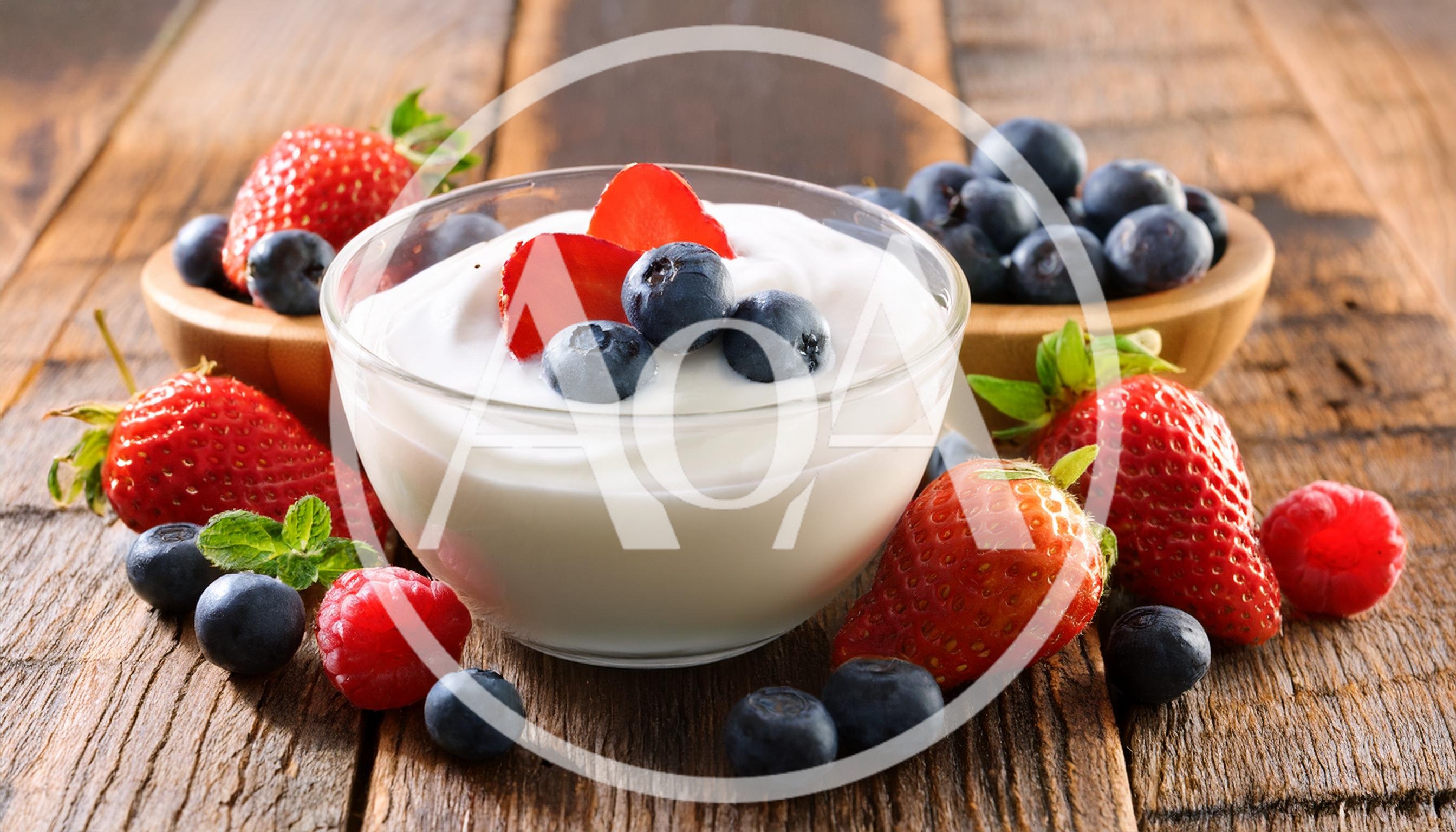 Bowl Of Yogurt With Fresh Berries On Wooden Table