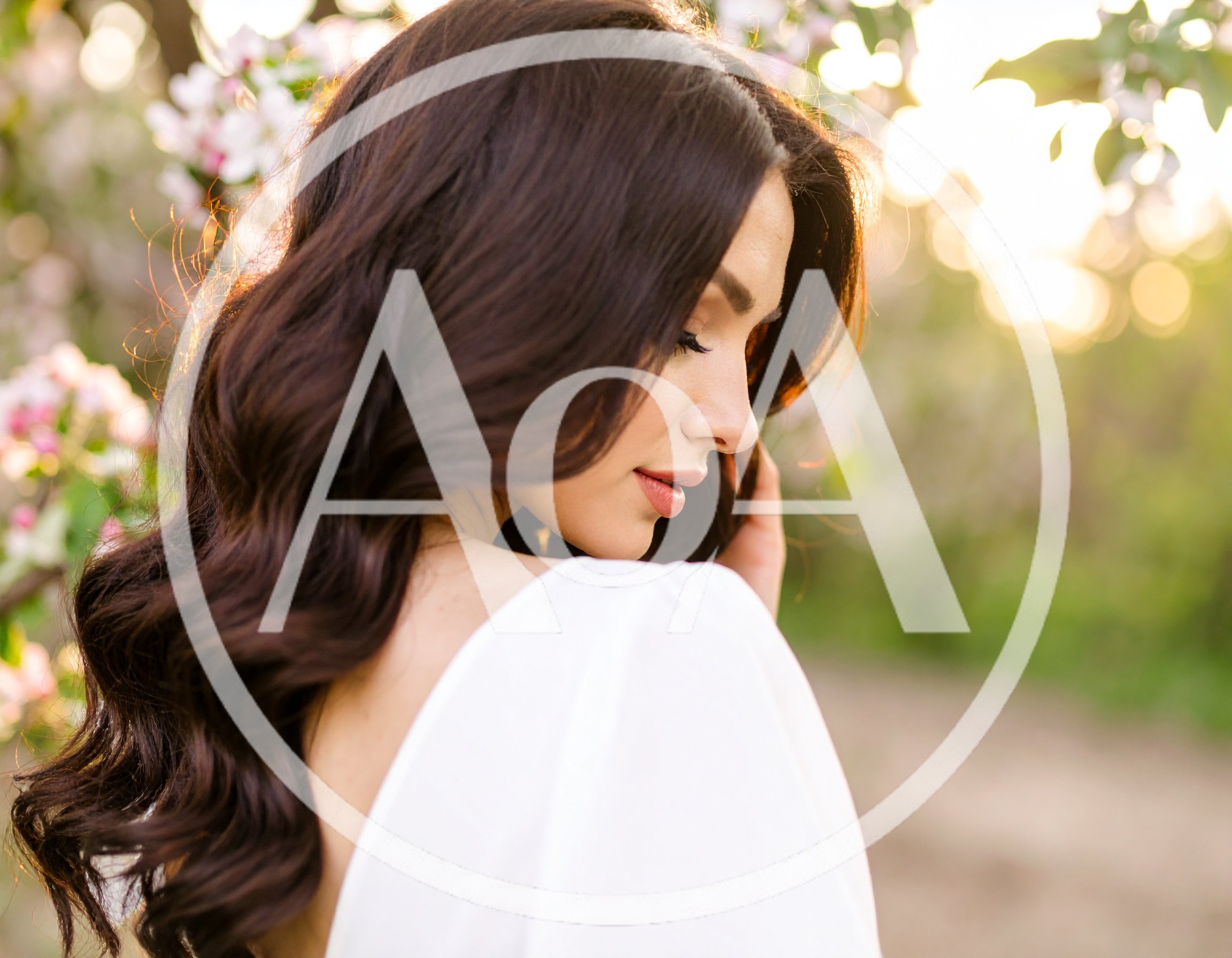 Beautiful Woman With Long Wavy Hair In Spring Garden