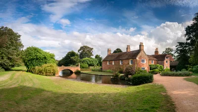 Historic Brick House With Stone Bridge Over River