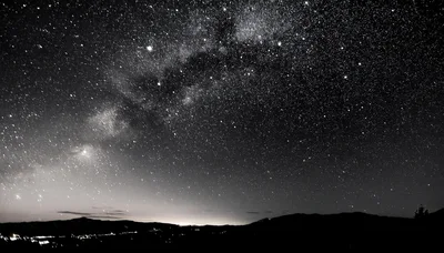 Milky Way Galaxy Over A Dark Mountain Landscape