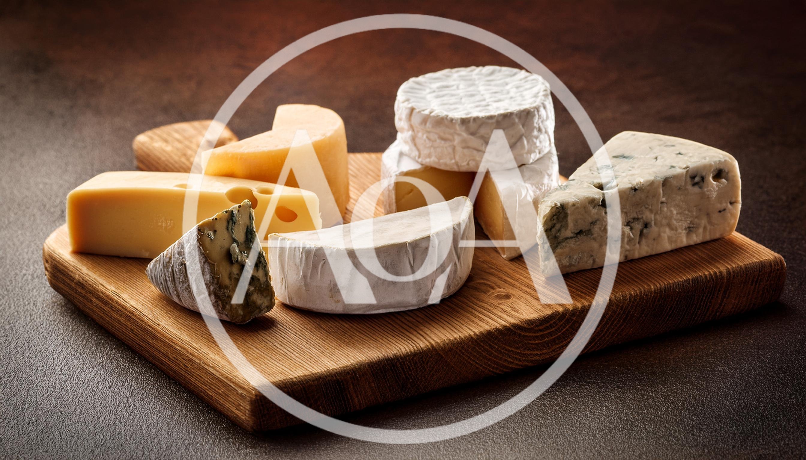 Assorted Gourmet Cheeses Arranged on a Wooden Board