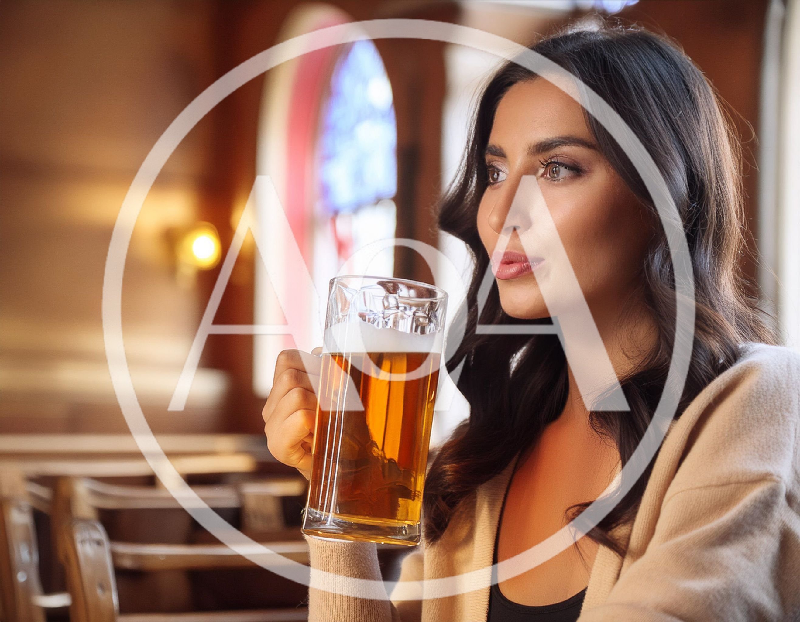 Young Woman Holding A Glass Of Beer In A Pub