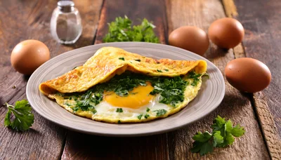 Freshly Cooked Omelet With Herbs On A Plate