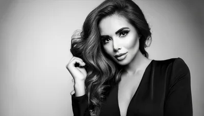 Glamorous Woman With Wavy Hair Posing In Studio