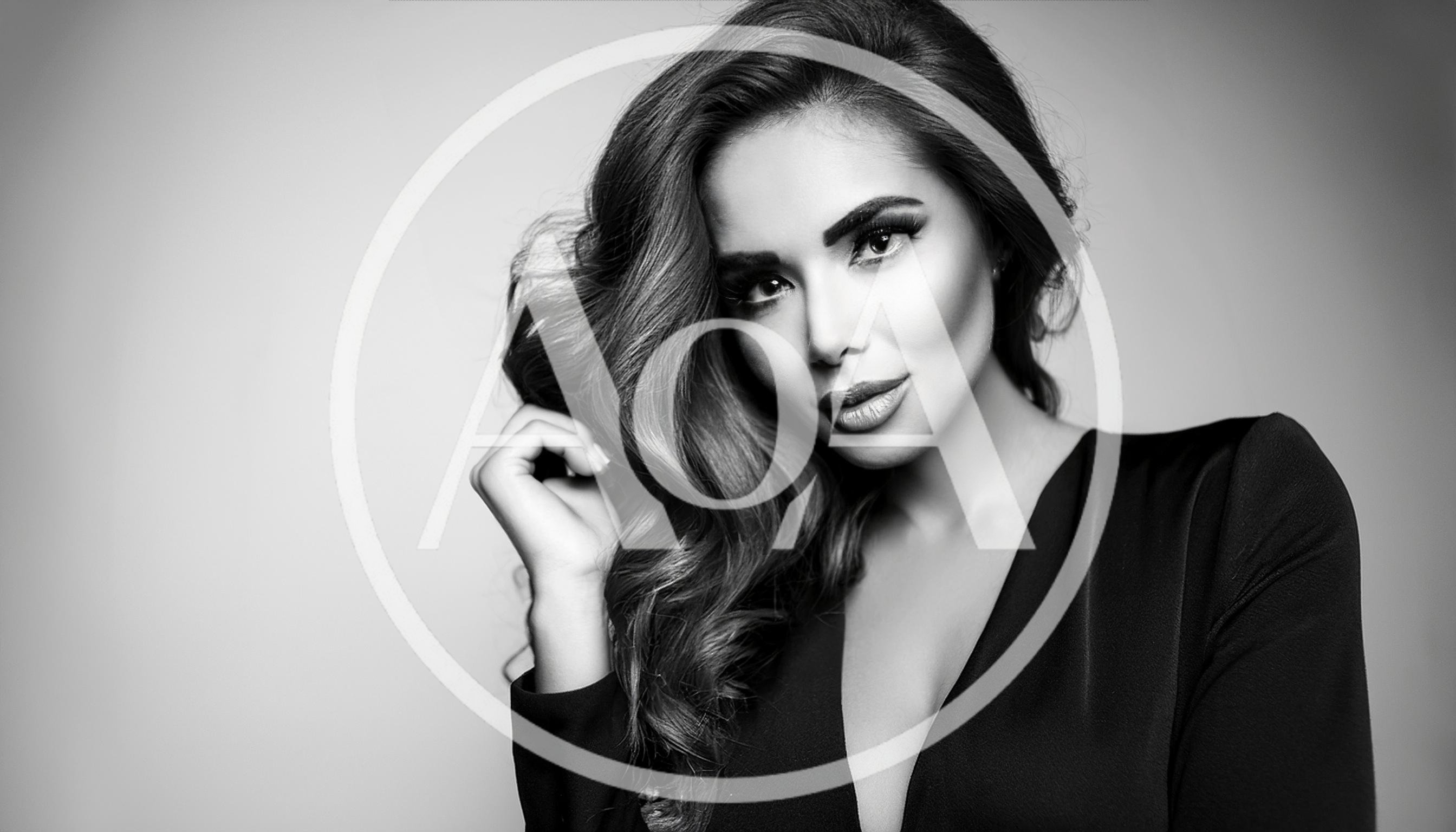 Glamorous Woman With Wavy Hair Posing In Studio