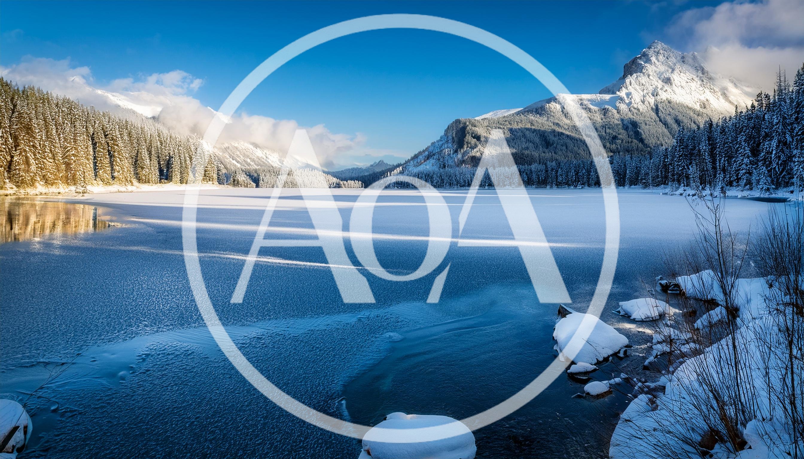 Frozen Lake Surrounded By Snow Covered Mountains