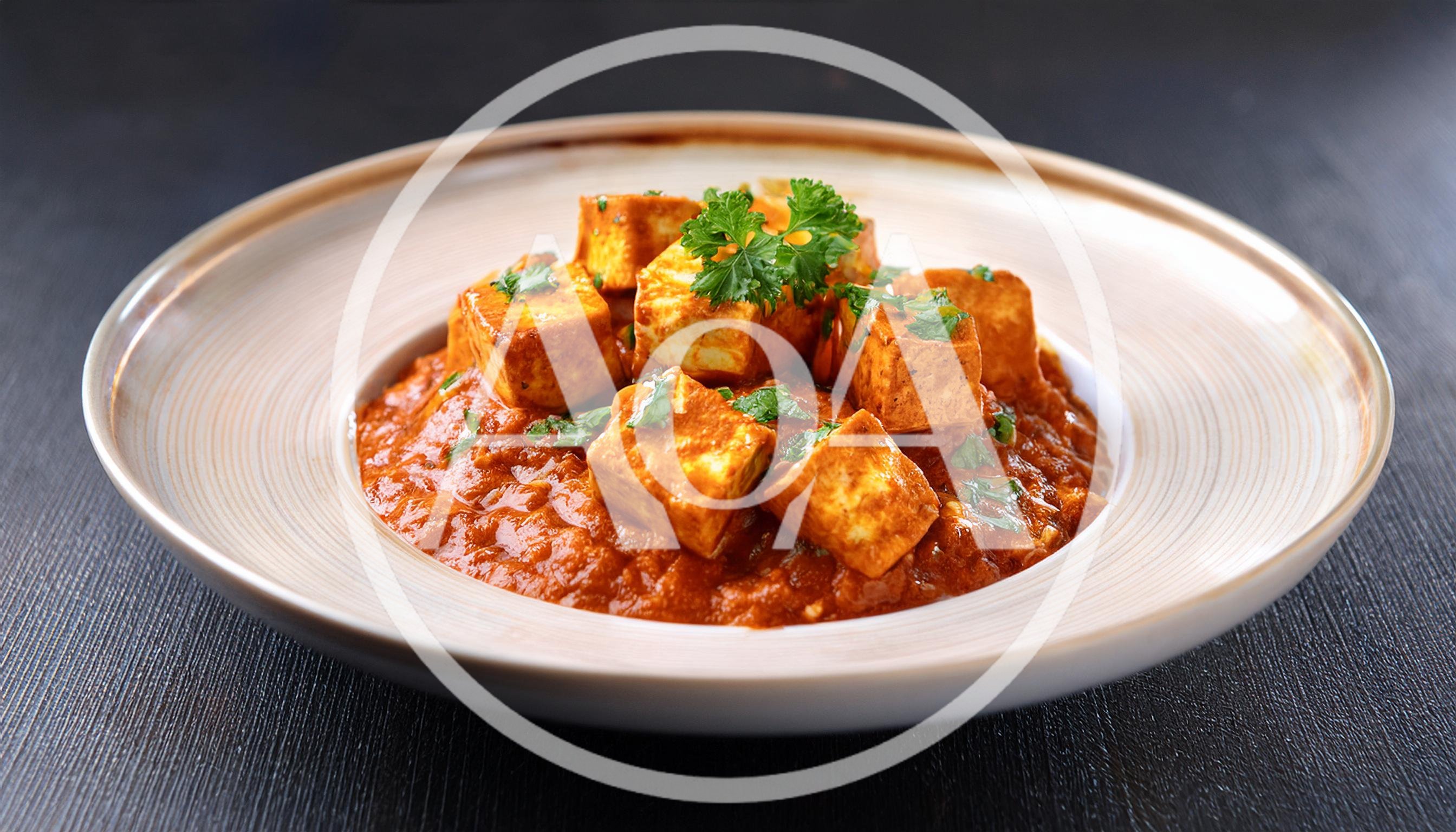 Paneer Butter Masala Served In A Shallow Bowl