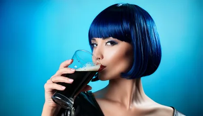 Woman With Blue Bob Hair Drinking Dark Beer