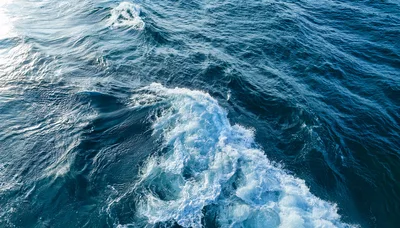 Aerial View Of Ocean Waves And White Sea Foam