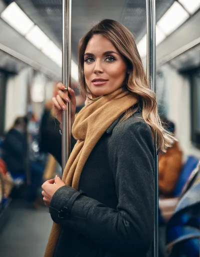 Young Woman Standing Inside A Subway Train Car