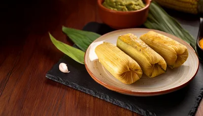 Three Traditional Corn Tamales Served on a Plate