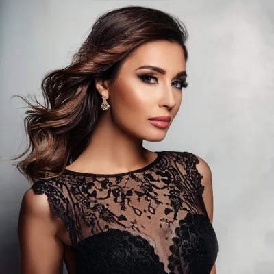 Elegant Woman With Wavy Hair Wearing Black Lace Dress