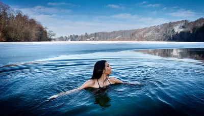 Woman Swimming In A Frozen Lake
