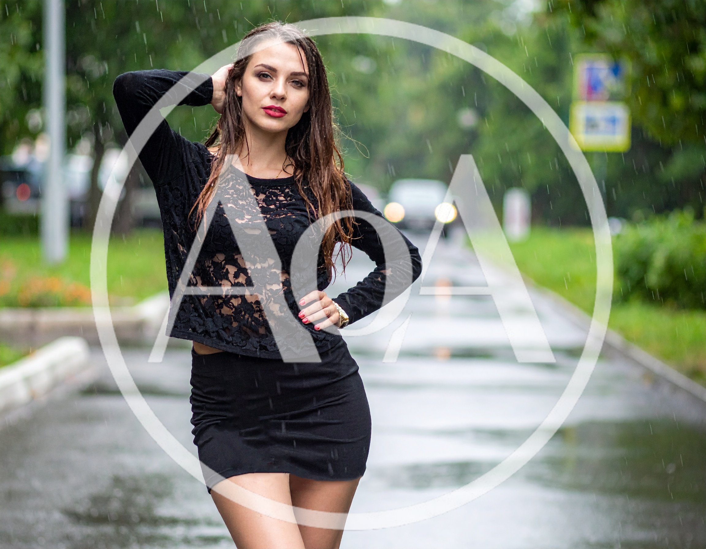 Young Woman Posing in Rain on City Street