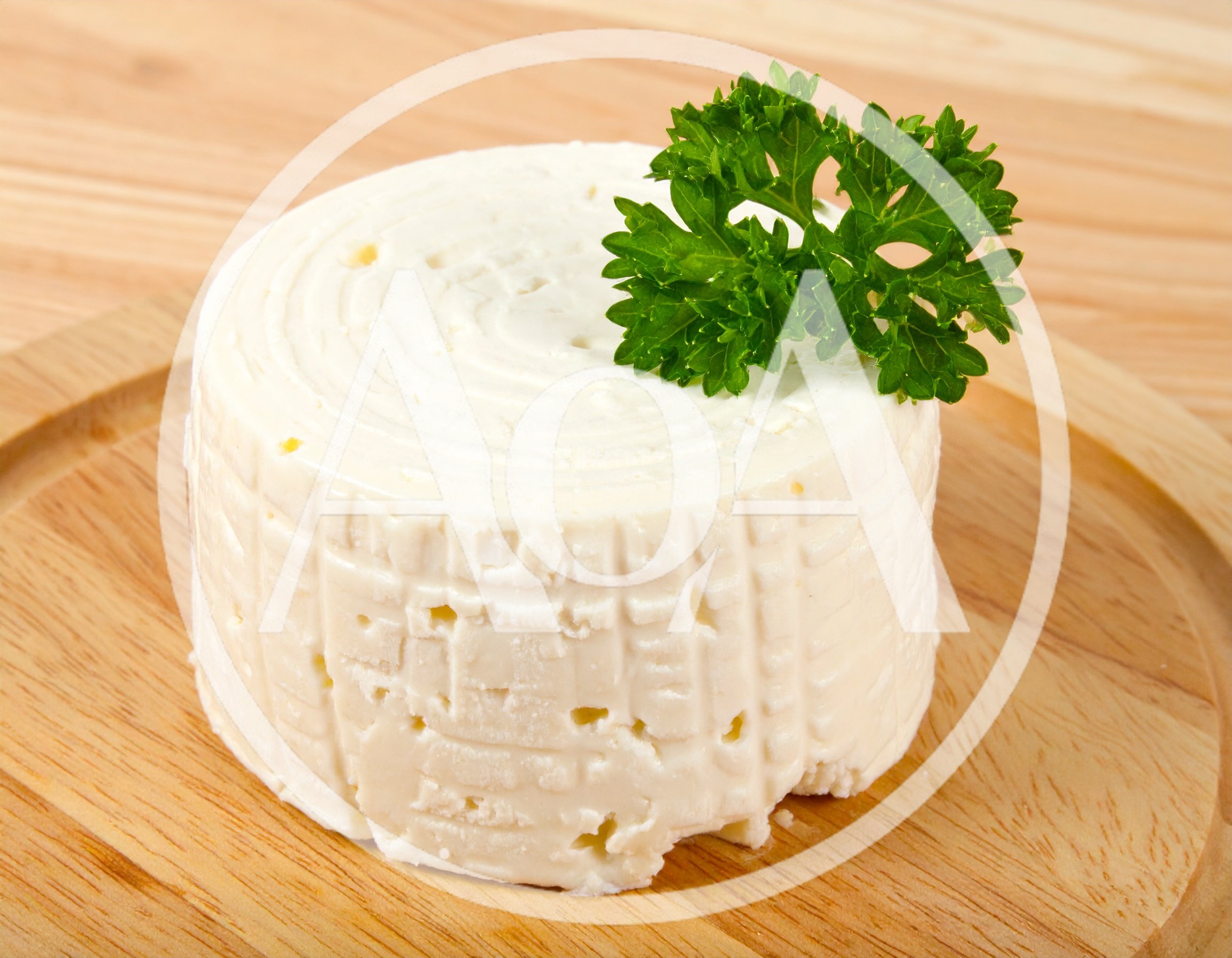 Fresh Round Cheese Wheel With Parsley Garnish