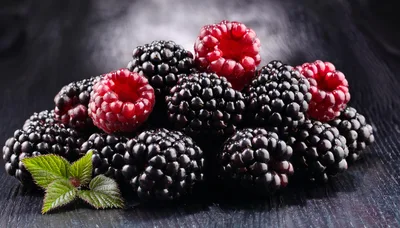 Fresh Blackberries and Raspberries on Dark Wooden Surface