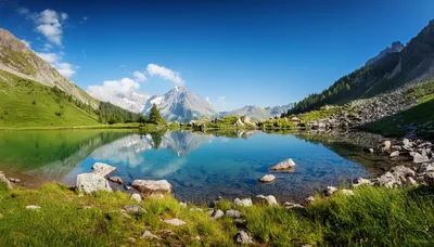 Alpine Lake Reflection Under Clear Blue Sky